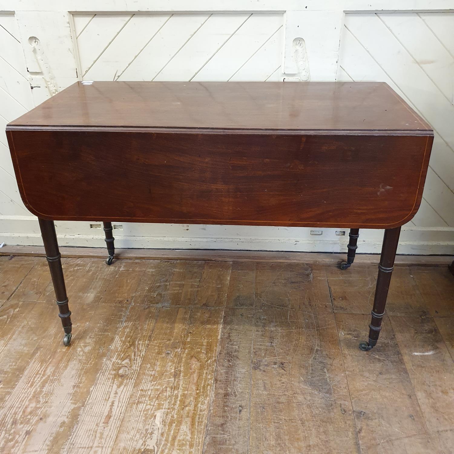 An early 19th century mahogany Pembroke table, on tapering turned legs, 103 cm wide