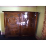 A George III style mahogany two door wardrobe, carved leaves and rosettes, 132 cm wide, removal cost