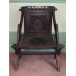 A Glastonbury carved oak armchair, removal cost B