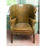 A George III style leather upholstered armchair, on tapering chamfered square front legs, removal