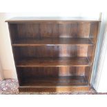 A stained pine open bookcase, on a plinth base, 122 cm wide, removal cost C Report by RB General