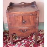 A George III mahogany tray top night commode, having a brushing slide above a pair of panel doors,