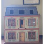 A late 19th/early 20th century three storey doll's house, No 5, with a large group of assorted