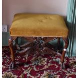 A Queen Anne style carved walnut stool, on cabriole legs with hairy paw feet, 60 cm wide, removal