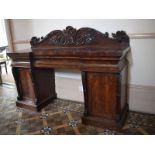 An early Victorian mahogany pedestal sideboard, the back carved scrolling acanthus leaves and