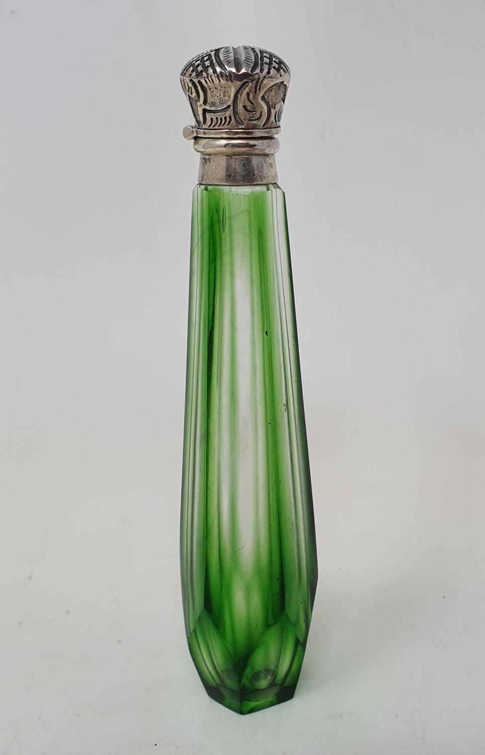 A green glass scent bottle, with silver coloured metal mounts, 12 cm Report by JS Overall