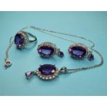 A silver and amethyst ring, a matching pendant and earrings