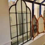 A pair of cast metal framed mirrors, 146 x 90 cm