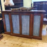 A breakfront mahogany bookcase/cabinet, having two pairs of doors with brass grilles, 192 cm wide