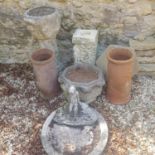 A composite stone planter, raised on column support to square base, 90 cm high, a pair of terracotta