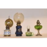 A late 19th/early 20th century spelter oil lamp, with green glass well, and nine others (10) A brass