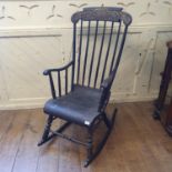 A painted rocking armchair, the crest rail with gilt decoration Ware to the turned support on