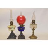 A late 19th/early 20th century spelter oil lamp, with painted blue glass well, and five others (6)