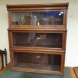 Three sections of a Globe-Wernicke oak bookcase, an Ercol coffee table, a bookstand, an oak chair,