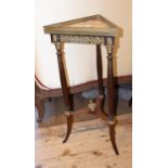 A 19th century French mahogany triangular stand, on turned supports united by a stretcher and a