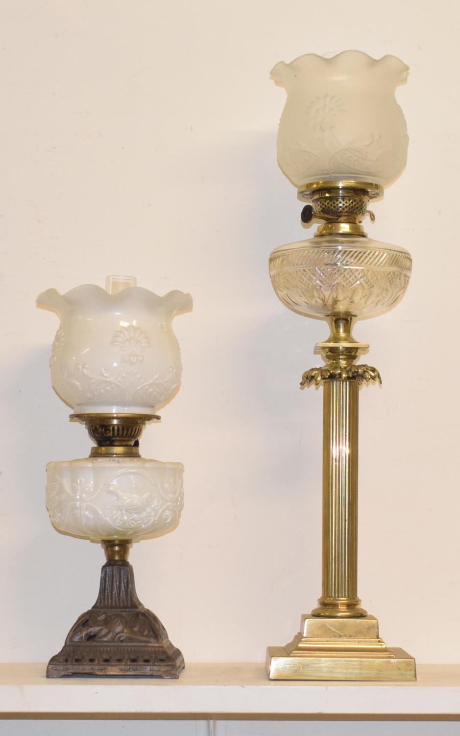 A 19th century gilt metal oil lamp, in the form of a column with clear glass well, 80 cm high, and