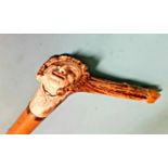A 19th century Malacca walking stick with carved deer antler handle, in the form of a grotesque