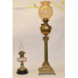 A late 19th/early 20th century brass and onyx oil lamp, in the form of a column, with amber glass