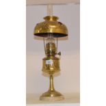 An Arts and Crafts style brass oil lamp, shade inset with amber glass, 57 cm high