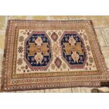 An Afghan red ground rug, 185 x 114 cm, a red ground runner, 270 x 77 cm, and a cream ground rug,
