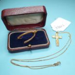 A 9ct gold wishbone brooch, and a 9ct gold cross on a chain, approx. 4.6 g (all in)