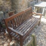 A teak garden bench, another, and a garden bench with cast metal ends, with lion head handles (3)