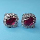 A pair of 18ct white gold treated ruby and diamond cluster studs, boxed, rubies 5.54ct, diamonds (