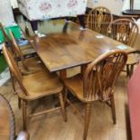 An oak refectory style dining table and a set of six hoop back dining chairs (7)