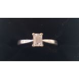 A solitaire diamond ring, baguette cut diamond, in 18ct white gold mount, diamond cluster ring,