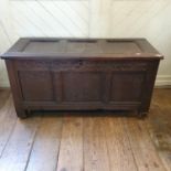 An 18th century carved oak coffer, on stile legs, 118 cm wide