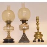 A late 19th/early 20th century brass oil lamp, with engraved glass shade, four other oil lamps and a