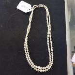 A two row graduated cultured pearl necklace, the 9ct white gold clasp with a rose cut diamond to the