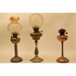 A late 19th/early 20th century brass oil lamp, with engraved glass shade, and five others (6)