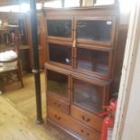 A set of three Minty mahogany sectional bookcases, and a chair