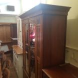 An early 20th century walnut wardrobe, with a mirrored door, 140 cm wide