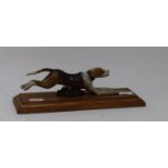 A painted bronze running dog paperclip, on an oak base, 28 cm wide Report by RB Modern