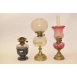 A brass oil lamp, with clear glass shade, and five others (6) Rough areas to touch on base of shade,