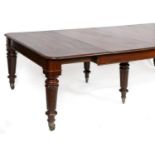 A 19th century mahogany extending dining table, the top inset three extra leaves, on six turned