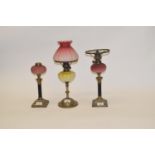 An oil lamp, with a yellow glass well, and a pair of oil lamps (3)