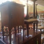 A early 20th century mahogany pot cupboard, a glass top coffee table, and two stools (4)