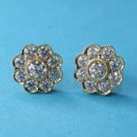A row of 18ct gold and diamond flowerhead style stud earrings