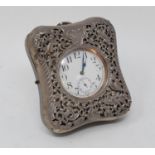 A late Victorian silver mounted pocket watch holder, dated 1898, pierced and embossed cherubs and