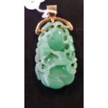 A Chinese carved jade pendant, on an 18ct gold mount, 7 cm high Gross weight 34.6 grams natural