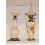 A 19th century porcelain oil lamp, decorated with flowers and butterflies, with gilt metal mounts,