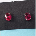A pair of treated ruby and silver stud earrings