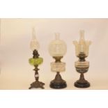 A late 19th/early 20th century spelter oil lamp with clear glass shade, and five others (6)