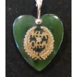 A modern jade heart shaped pendant, with yellow metal mount reading Kiaora, on yellow metal chain