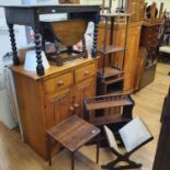 A pine cupboard, an oak table, an oak bedside table, a walnut wall shelf, an oval mahogany table,