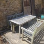 A teak garden table, a matching bench, and two armchairs (4)
