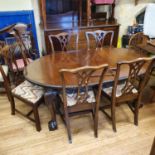 A mahogany dining room suite, comprising six dining chairs, oval extending dining table, and a